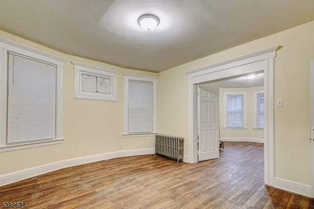 wooden floor in a hall with an empty room