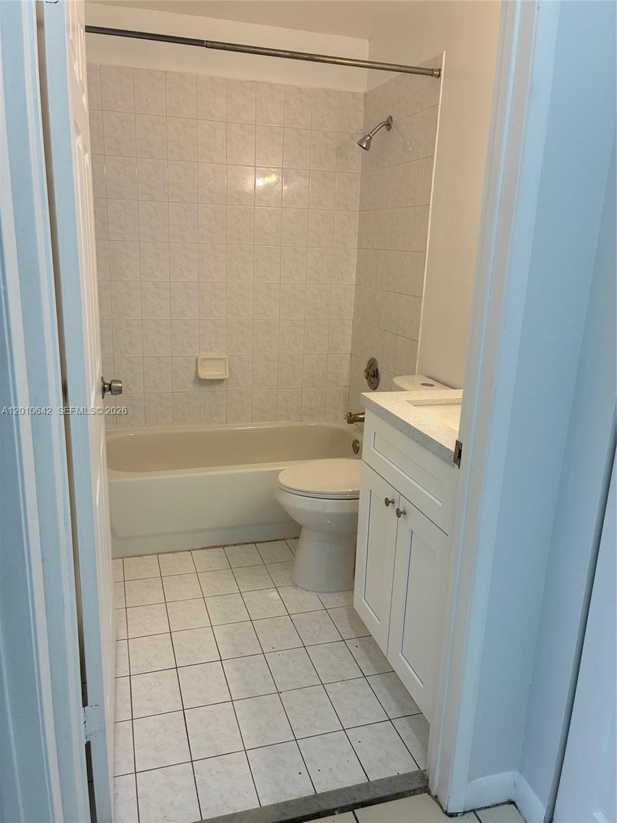 7640 Southwest 153rd Court, Unit 207 Miami, FL 33193 - Photo 5 of 8 a bathroom with a sink a toilet and shower