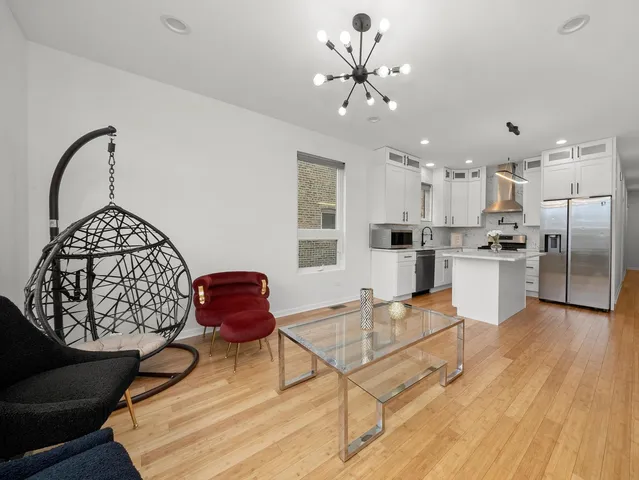 a view of kitchen with wooden floor electronic appliances and window