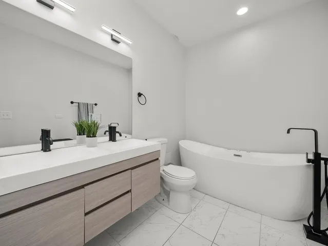 a kitchen with cabinets a sink and white appliances