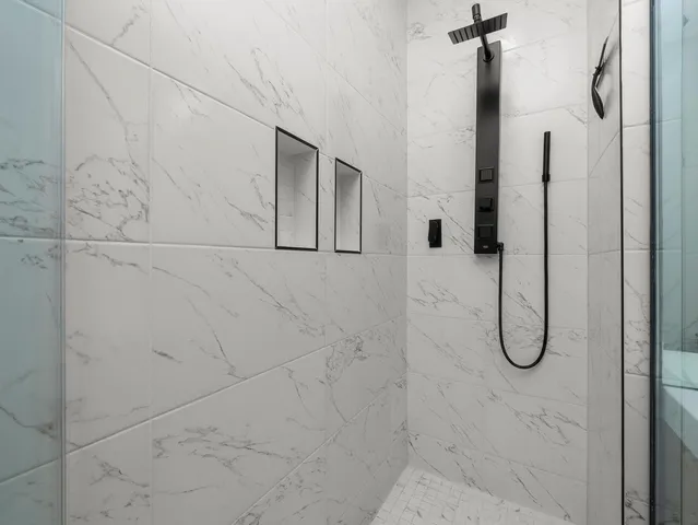 a large white kitchen with cabinets a sink and appliances