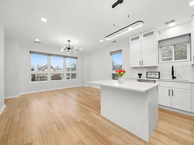 a kitchen with white cabinets and white appliances