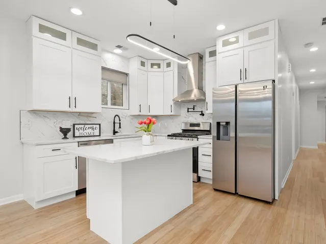 a living room with furniture and kitchen view