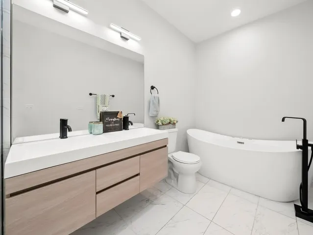 a bedroom with a bed and blue wall painting