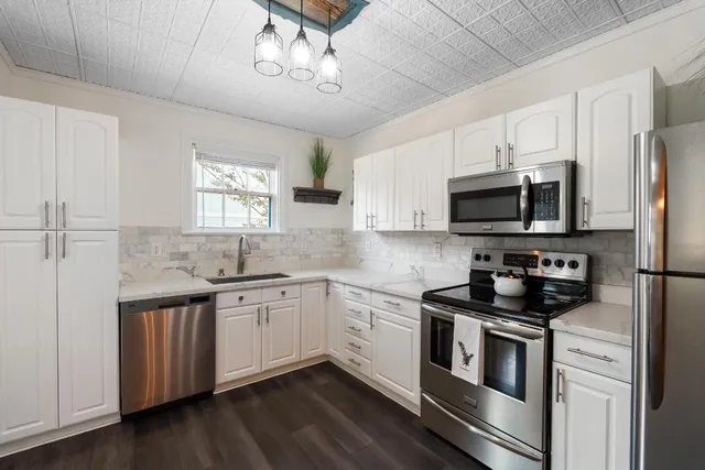 a kitchen with a refrigerator stove and sink