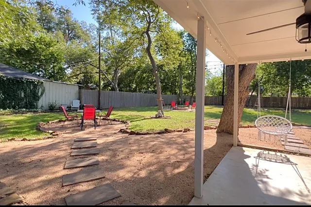 a view of a swimming pool with a table and chairs in a patio