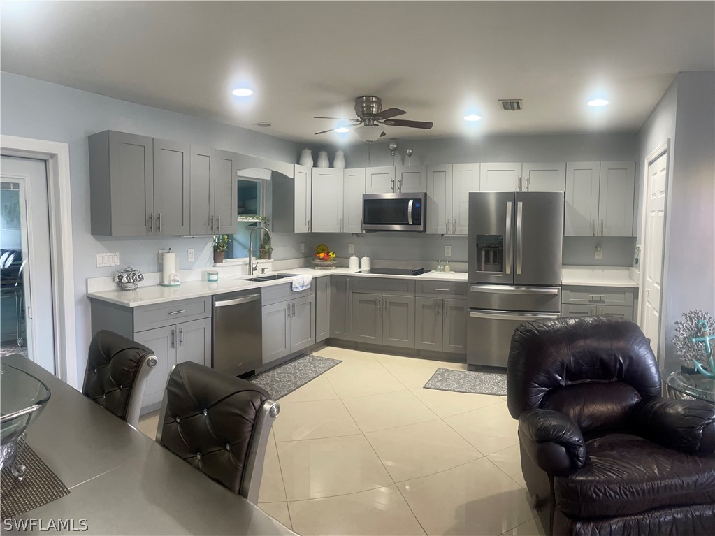 941 Happy Road North Fort Myers, FL 33903 - Photo 1 of 19 a kitchen with kitchen island a sink cabinets and stainless steel appliances