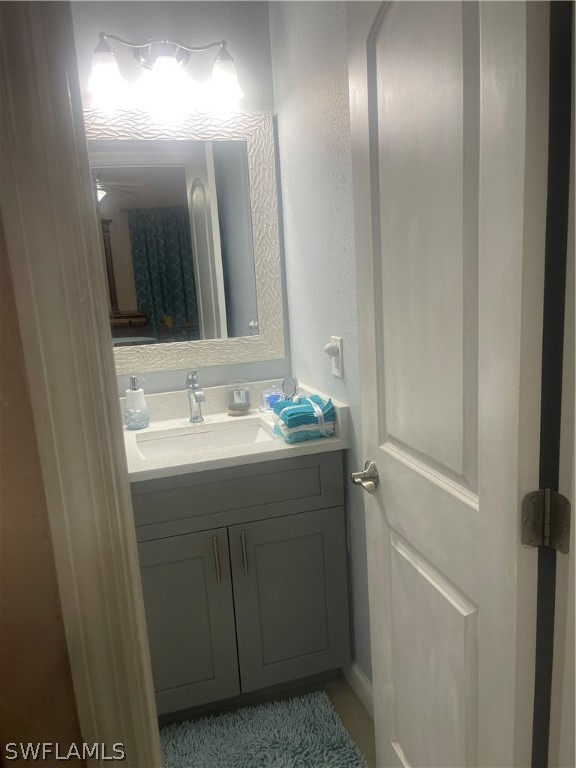 941 Happy Road North Fort Myers, FL 33903 - Photo 11 of 19 a bathroom with a sink and a mirror