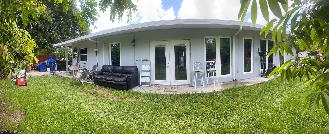 941 Happy Road North Fort Myers, FL 33903 - Photo 15 of 19 a view of a house with backyard porch and sitting area