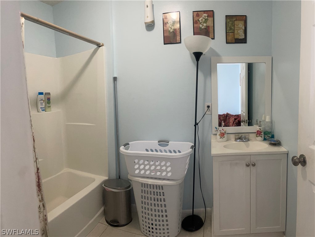 941 Happy Road North Fort Myers, FL 33903 - Photo 17 of 19 a bathroom with a sink a toilet and shower