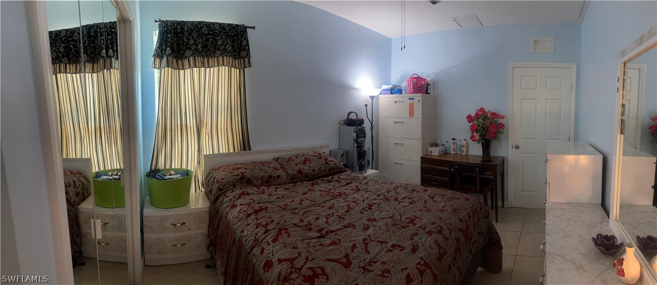 941 Happy Road North Fort Myers, FL 33903 - Photo 18 of 19 a bedroom with a bed and a window
