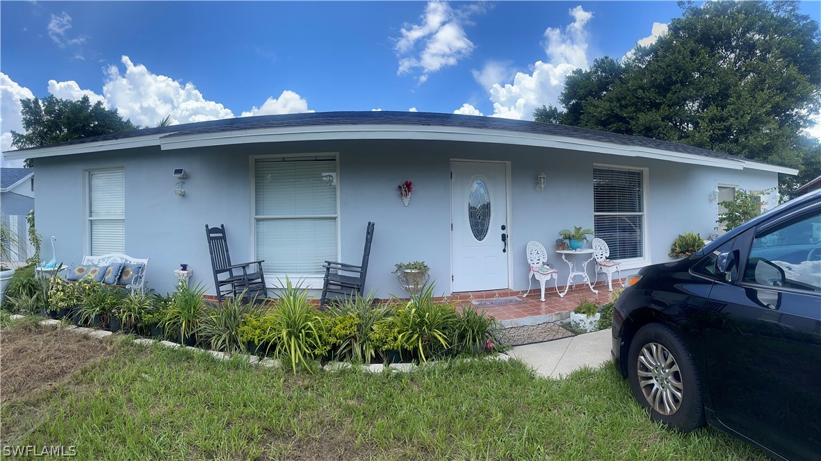 941 Happy Road North Fort Myers, FL 33903 - Photo 19 of 19 a front view of a house with garden