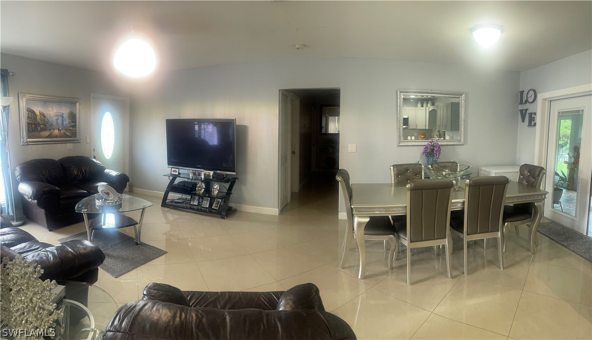 941 Happy Road North Fort Myers, FL 33903 - Photo 2 of 19 a living room with furniture and a flat screen tv
