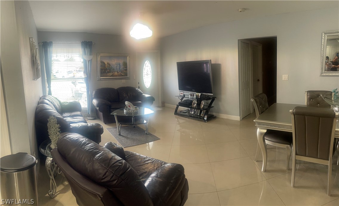941 Happy Road North Fort Myers, FL 33903 - Photo 3 of 19 a living room with furniture and a flat screen tv