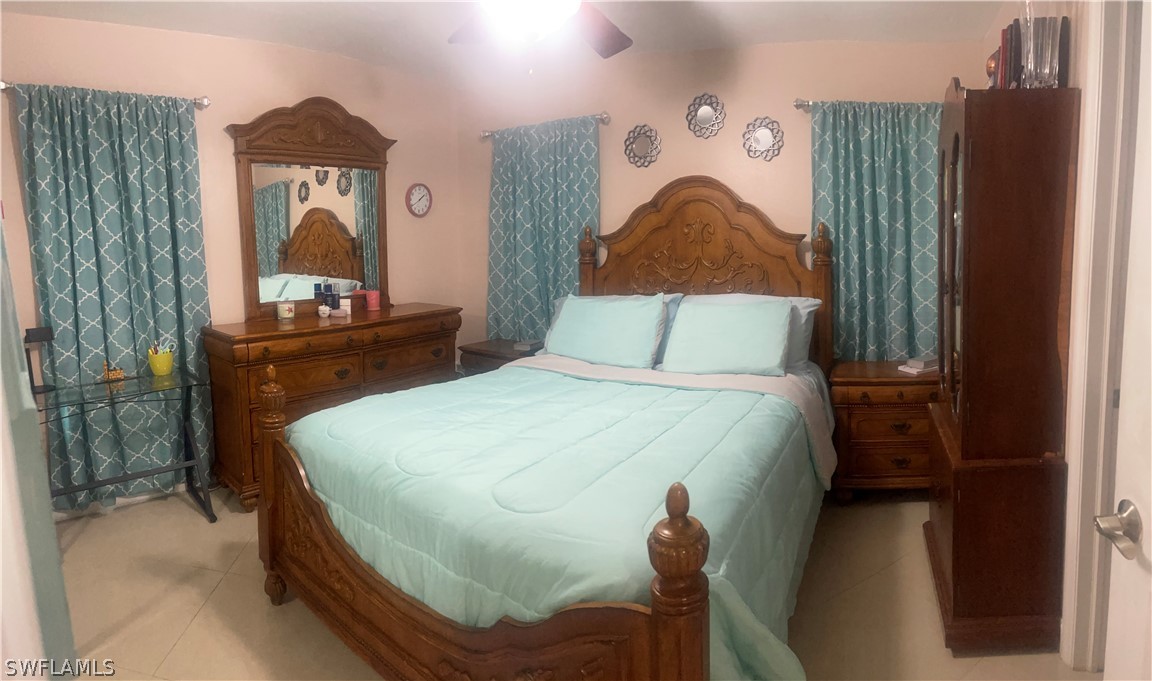 941 Happy Road North Fort Myers, FL 33903 - Photo 9 of 19 a bedroom with a bed and a dresser