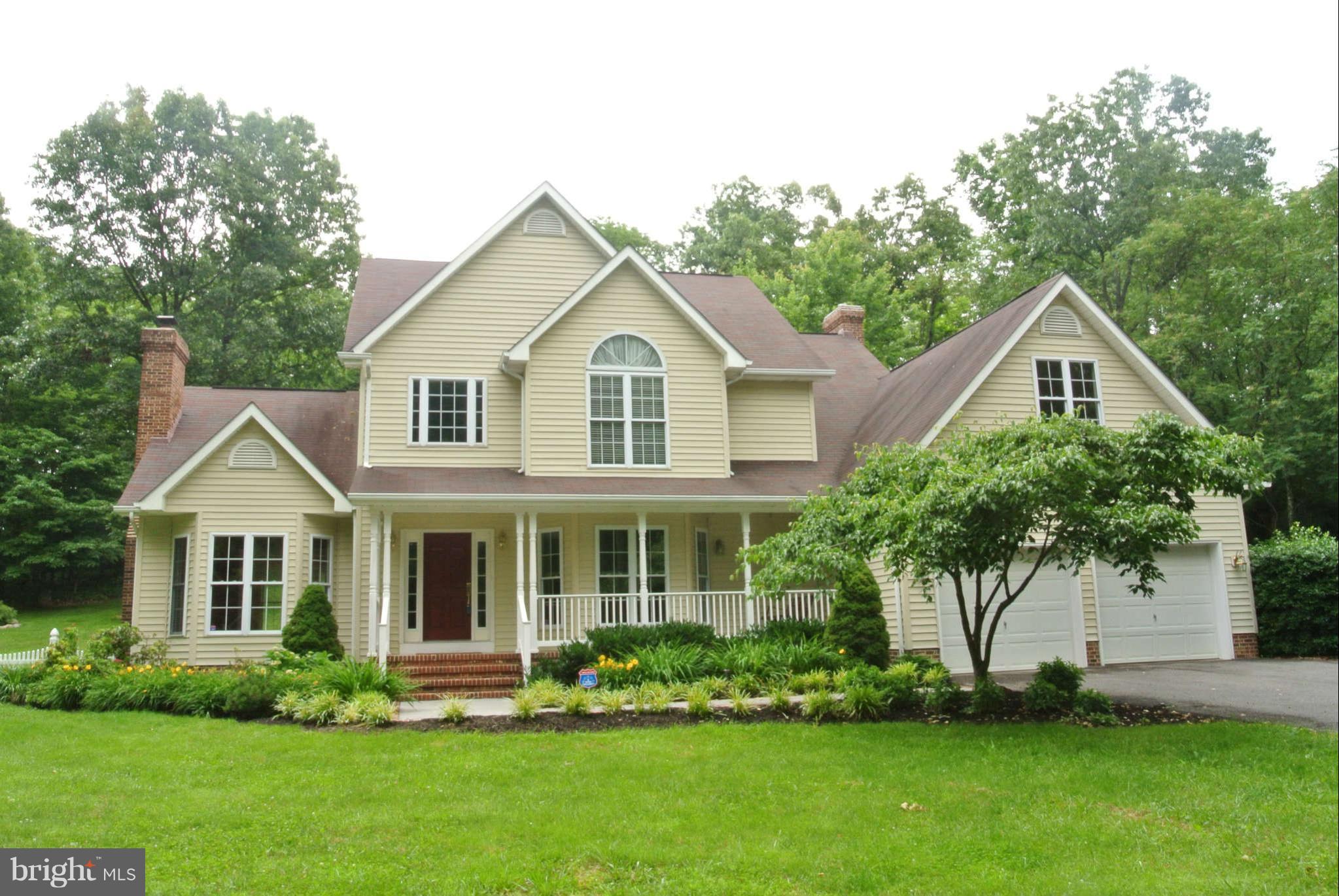 173 Cotton Ridge Road Winchester, VA 22603 - Photo 1 of 28 a front view of a house with a yard and trees