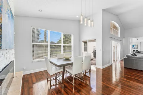 a view of a livingroom with furniture wooden floor and windows