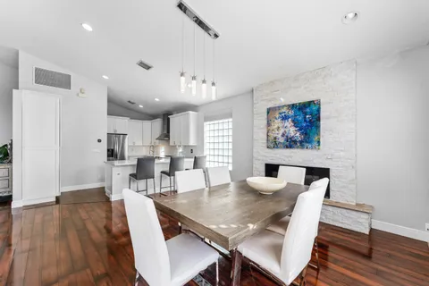 a dining room with furniture and wooden floor