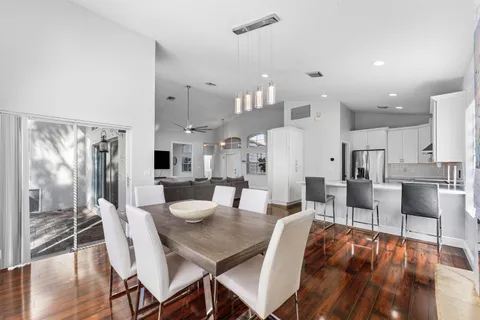 a view of a dining room with furniture wooden floor and chandelier