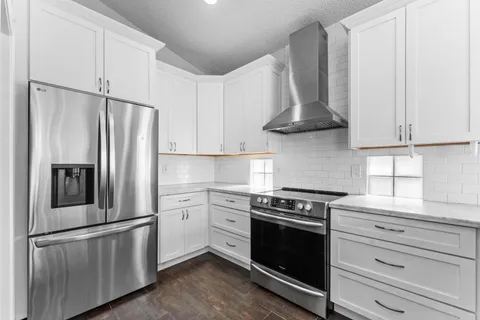 a kitchen with stainless steel appliances white cabinets and a stove