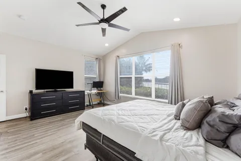 a bedroom with a bed and a flat screen tv