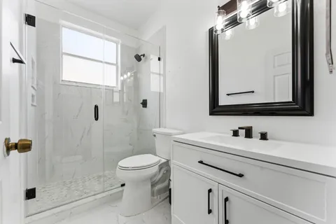 a bathroom with a sink a toilet and a mirror