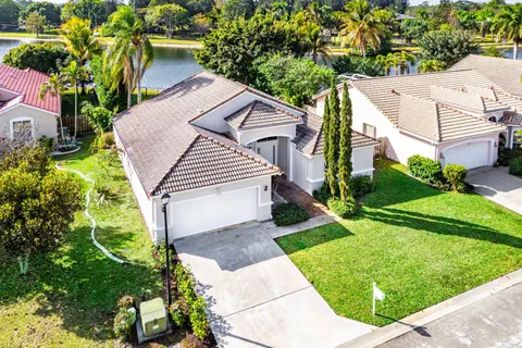 an aerial view of a house with a swimming pool and outdoor space
