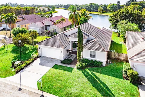an aerial view of a house with a yard and outdoor seating
