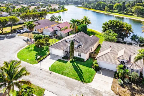 an aerial view of a house with garden space and a street sign on it