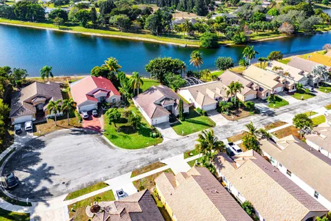 an aerial view of a house with a yard and lake view