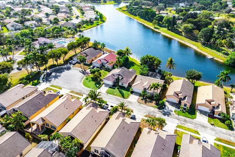 an aerial view of residential houses with outdoor space and river
