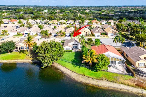 an aerial view of residential houses with outdoor space and river