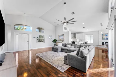 a living room with fireplace furniture and a wooden floor