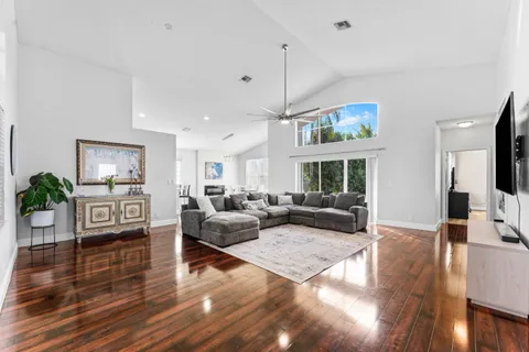 a living room with furniture fireplace and wooden floor