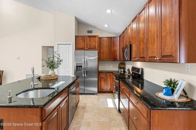 a kitchen with a table chairs and refrigerator