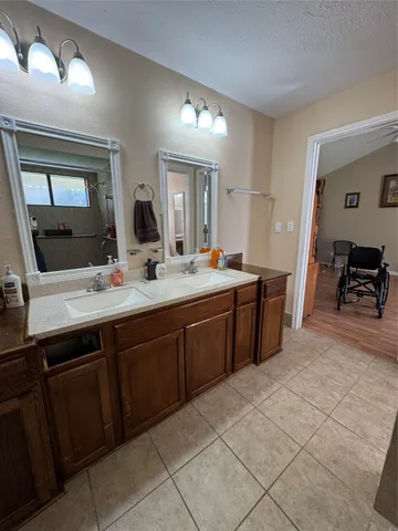 a spacious bathroom with a double vanity sink and a mirror
