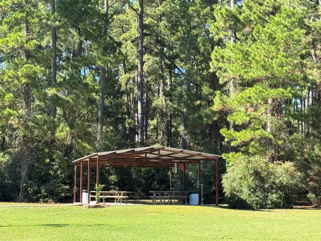 a patio with a table and chairs under an umbrella
