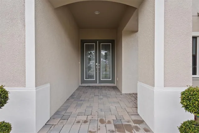 a view of a hallway with wooden floor and a window