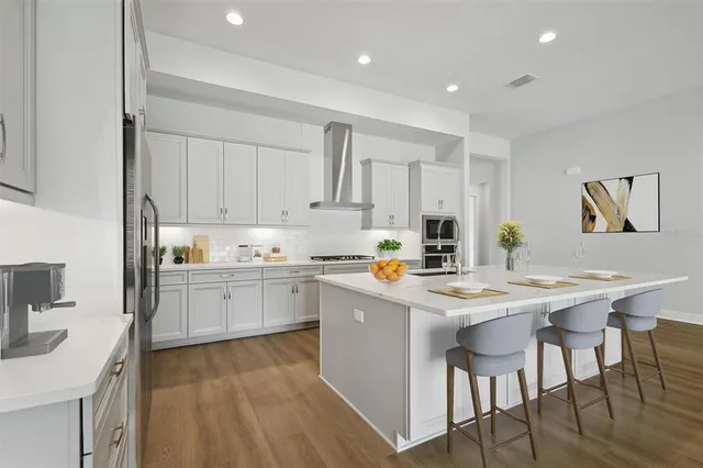 a kitchen with a stove a sink a dining table and chairs