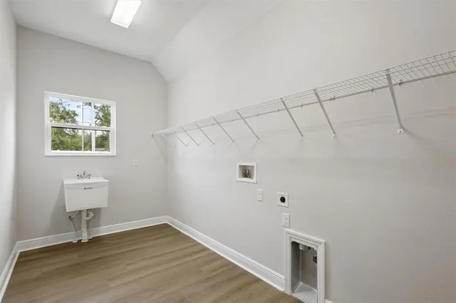 a view of small space with wooden floor and windows