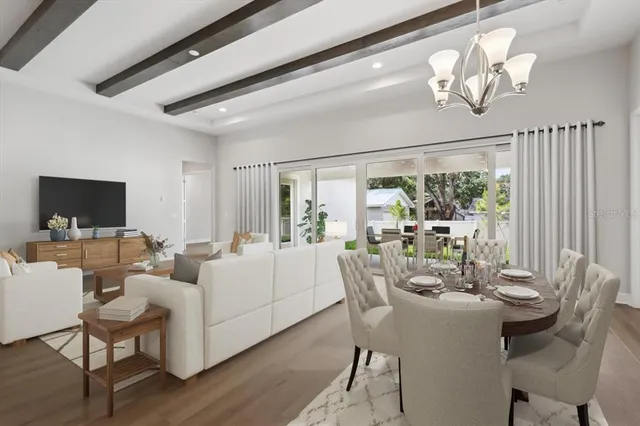 a view of a dining room with furniture a chandelier and wooden floor