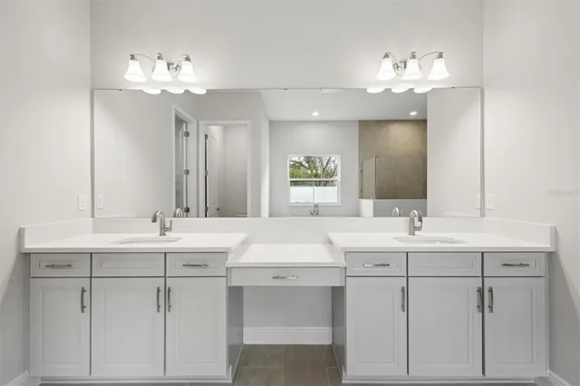 a bathroom with a sink vanity and mirror