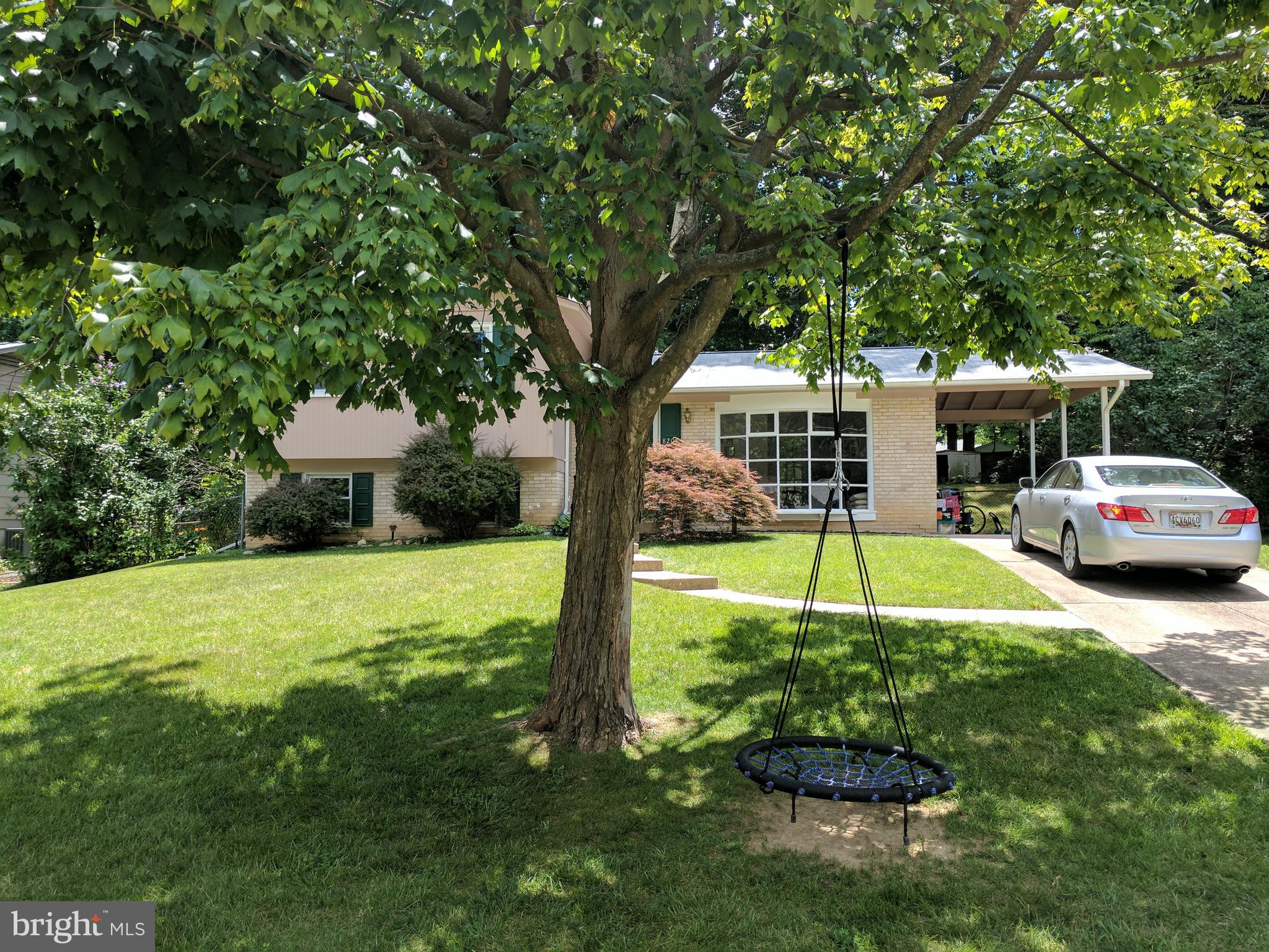 8207 Old Oaks Drive Springfield, VA 22152 - Photo 2 of 21 a view of a swimming pool with a table and chairs under an umbrella