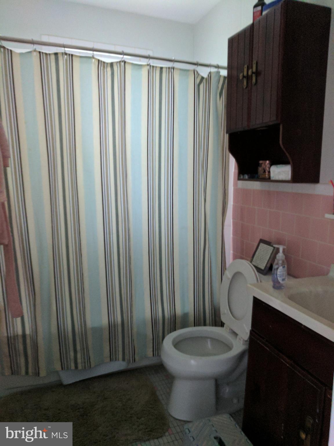 8207 Old Oaks Drive Springfield, VA 22152 - Photo 12 of 21 a bathroom with a toilet a sink and a mirror