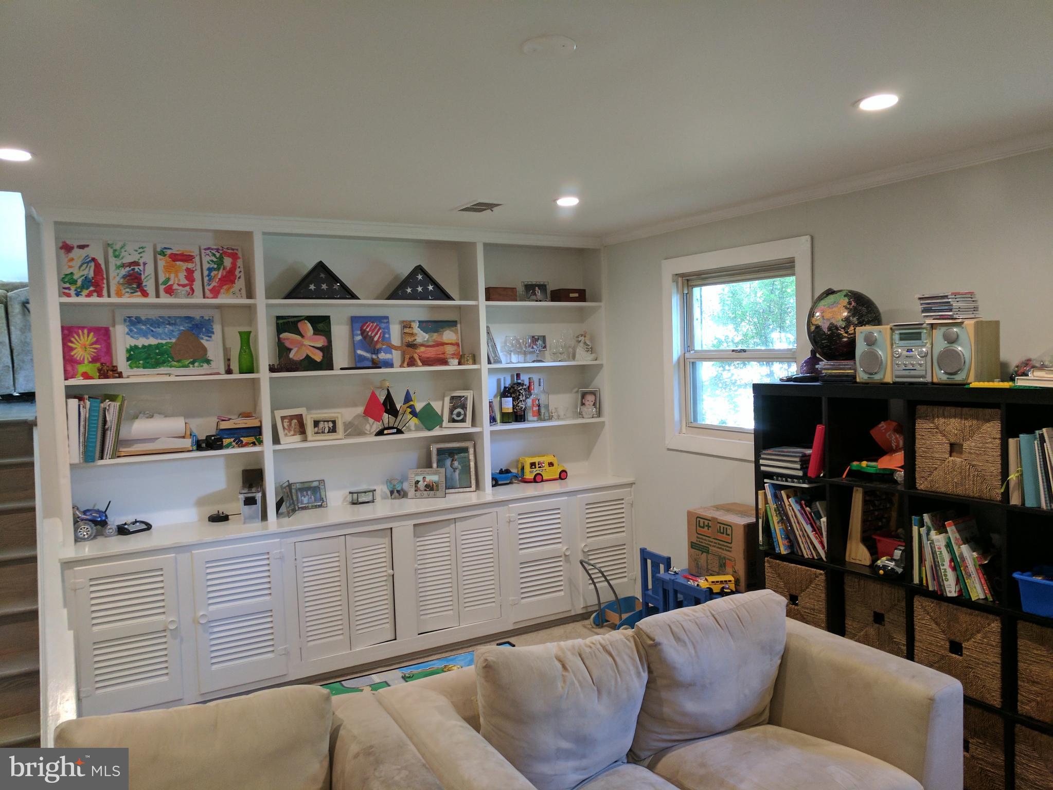8207 Old Oaks Drive Springfield, VA 22152 - Photo 15 of 21 a living room with furniture and a book shelf