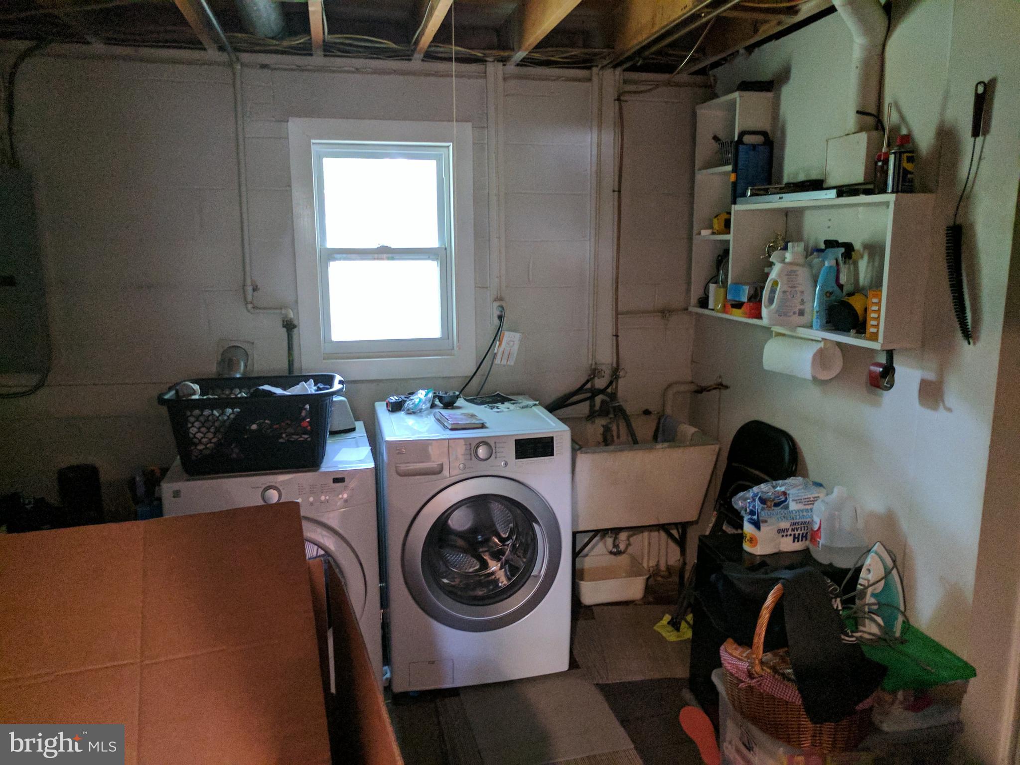 8207 Old Oaks Drive Springfield, VA 22152 - Photo 16 of 21 a utility room with dryer washer and a window
