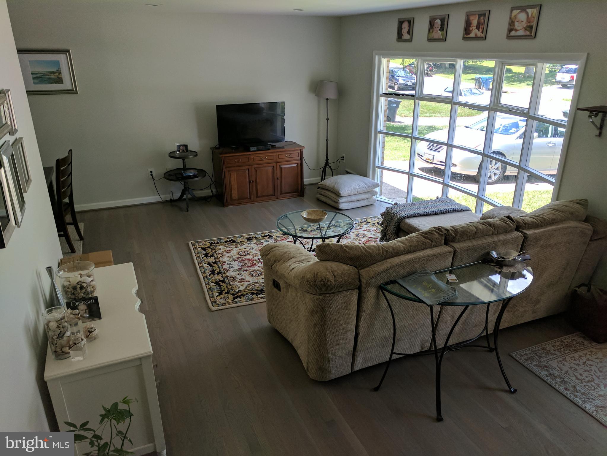 8207 Old Oaks Drive Springfield, VA 22152 - Photo 3 of 21 a living room with furniture and a flat screen tv