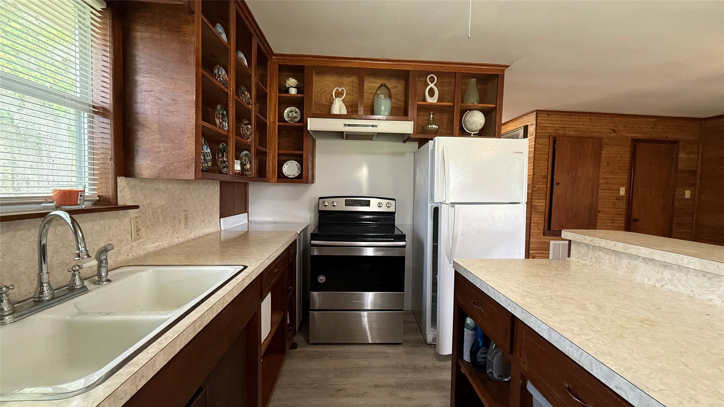 215 Weldon Livingston, TX 77351 - Photo 13 of 22 a kitchen with a sink and a refrigerator