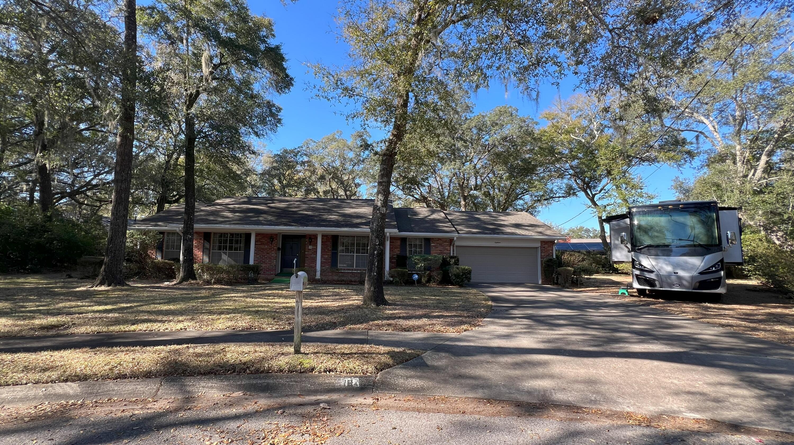 18 Sherwood Road Northwest Fort Walton Beach, FL 32547 - Photo 1 of 49 a house with trees in front of it