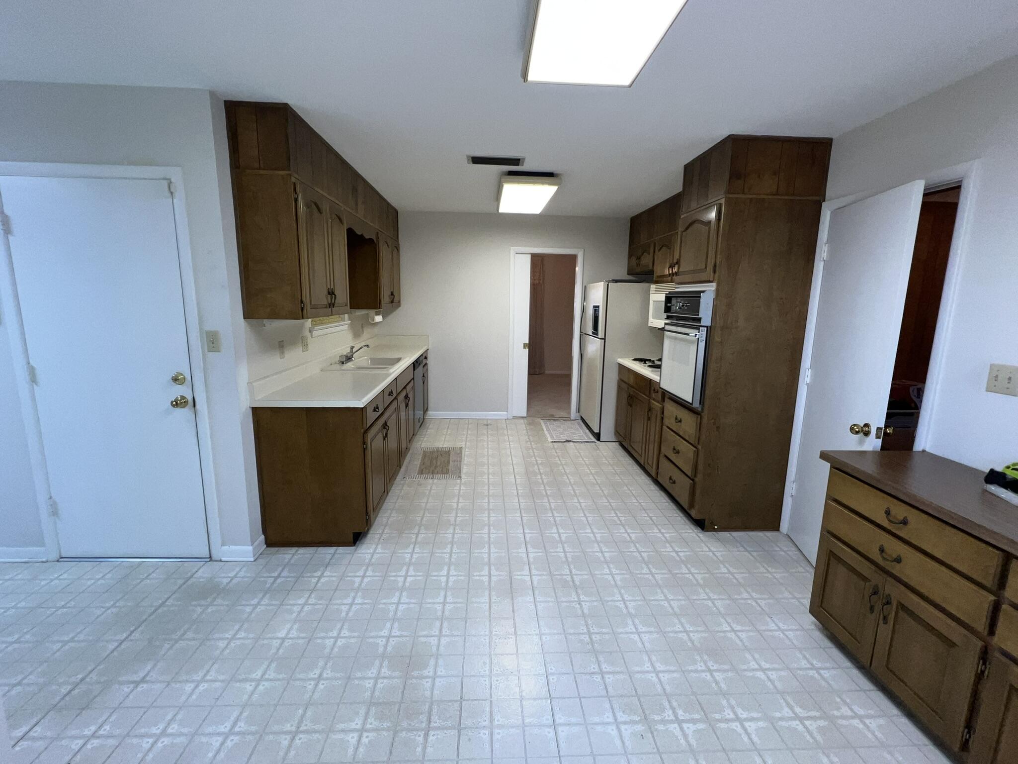 18 Sherwood Road Northwest Fort Walton Beach, FL 32547 - Photo 18 of 49 a kitchen with granite countertop a refrigerator and a stove top oven